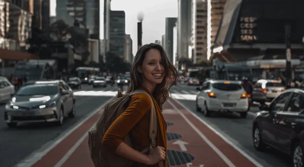 The girl walks along the road and smiles