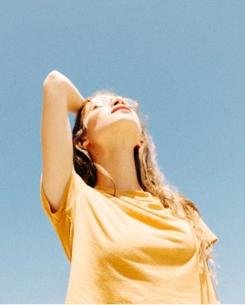 a girl in glasses in a yellow T-shirt