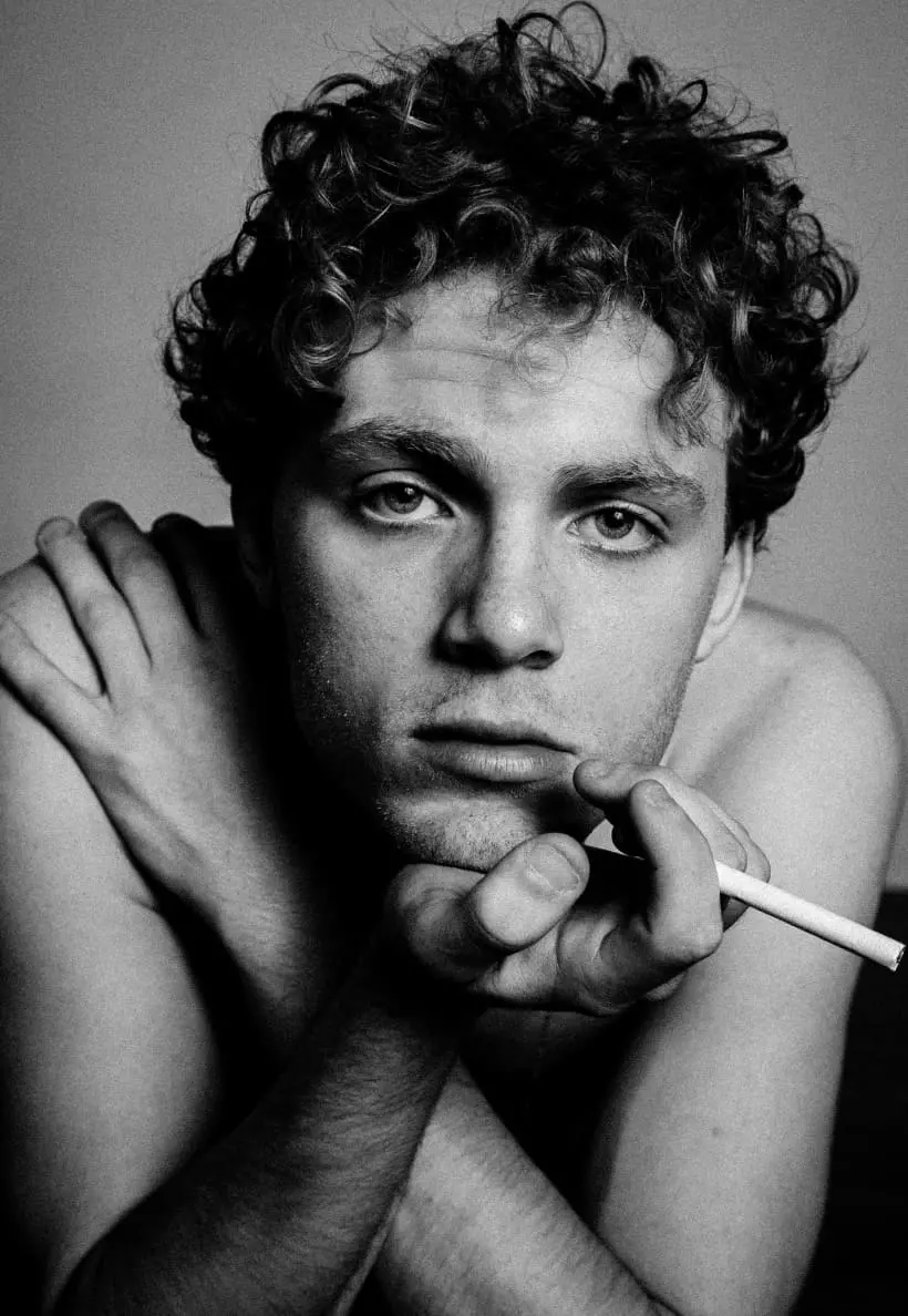 a man holds a cigarette in his hand