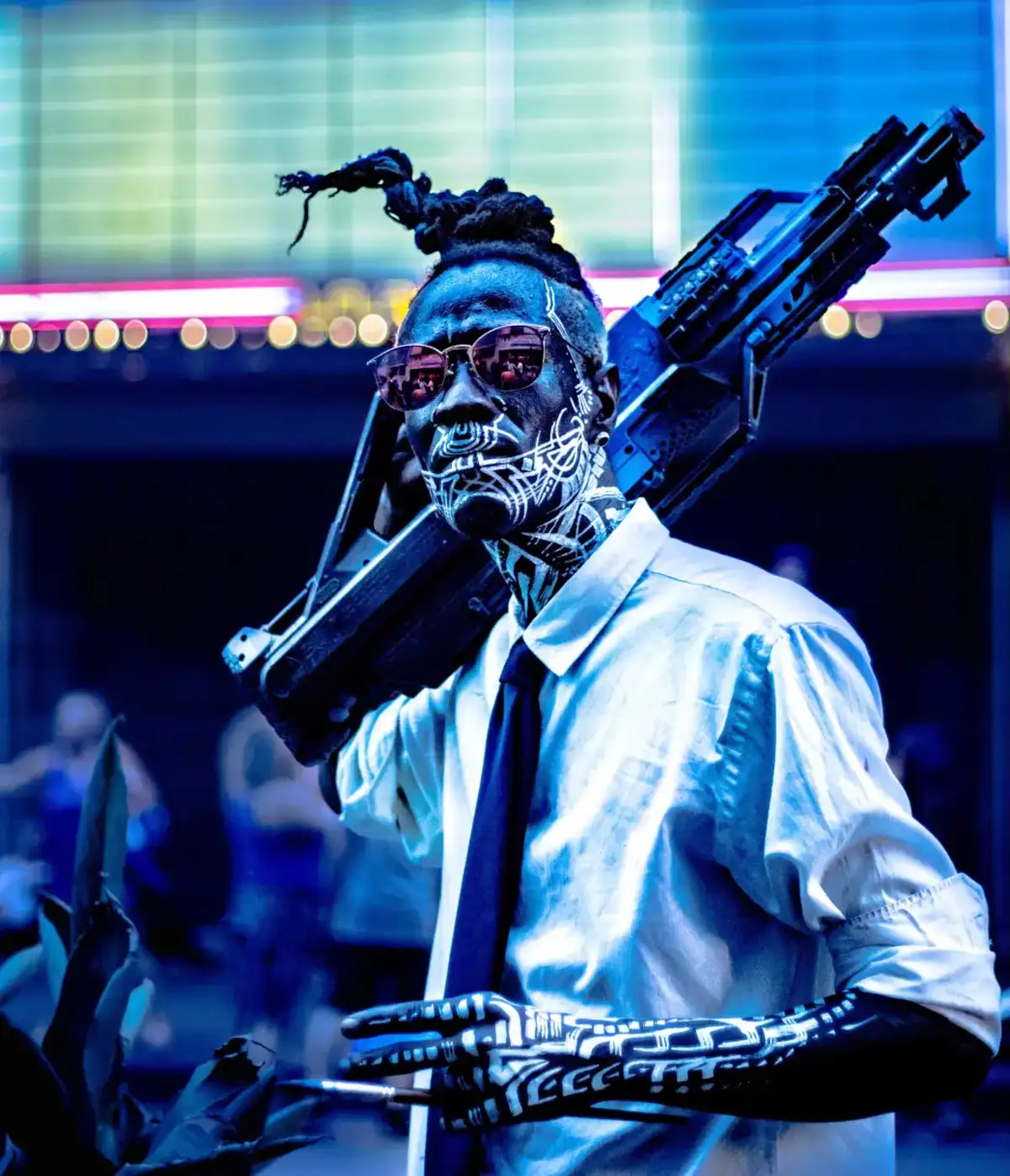 a man with a machine gun in a white shirt