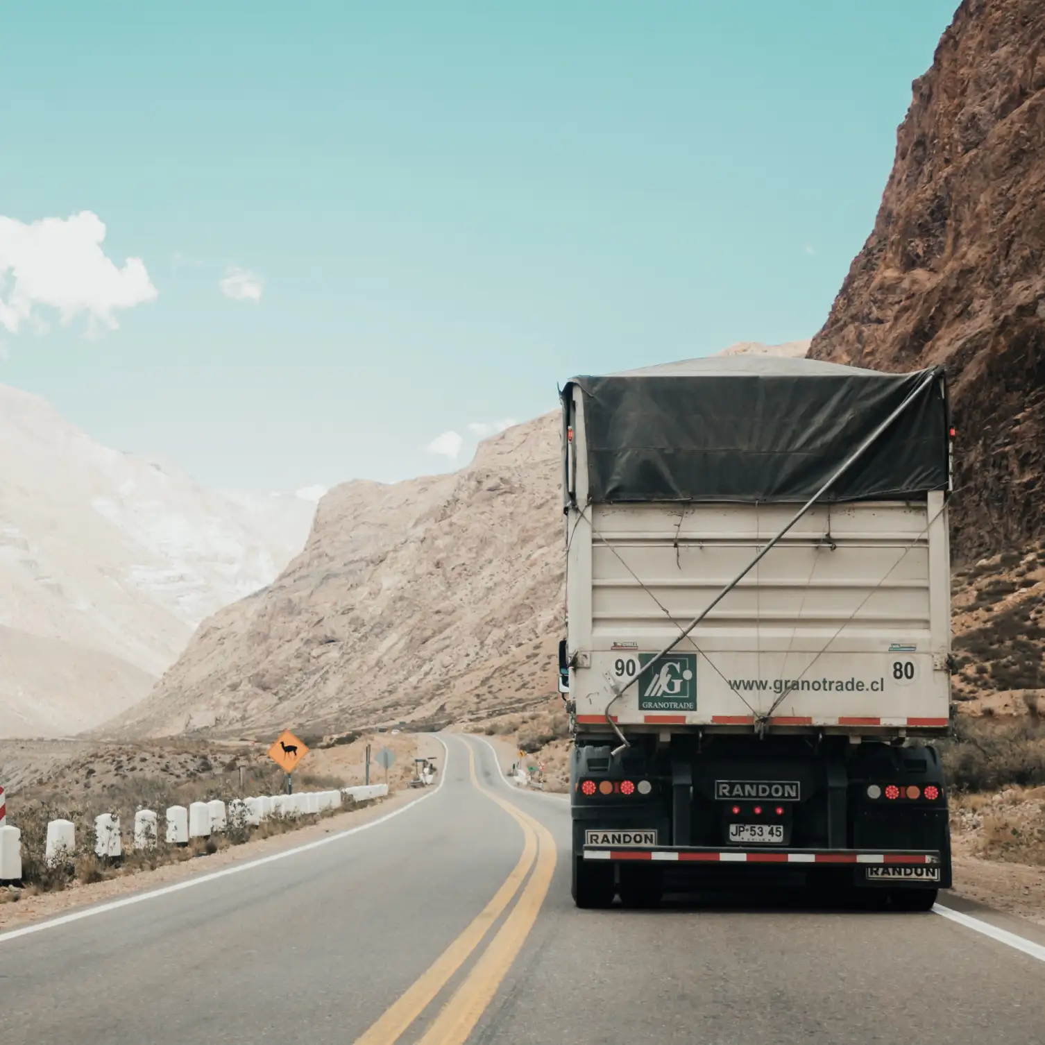 a truck is driving down the road