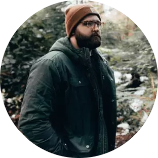 a guy with a beard in a hat and jacket