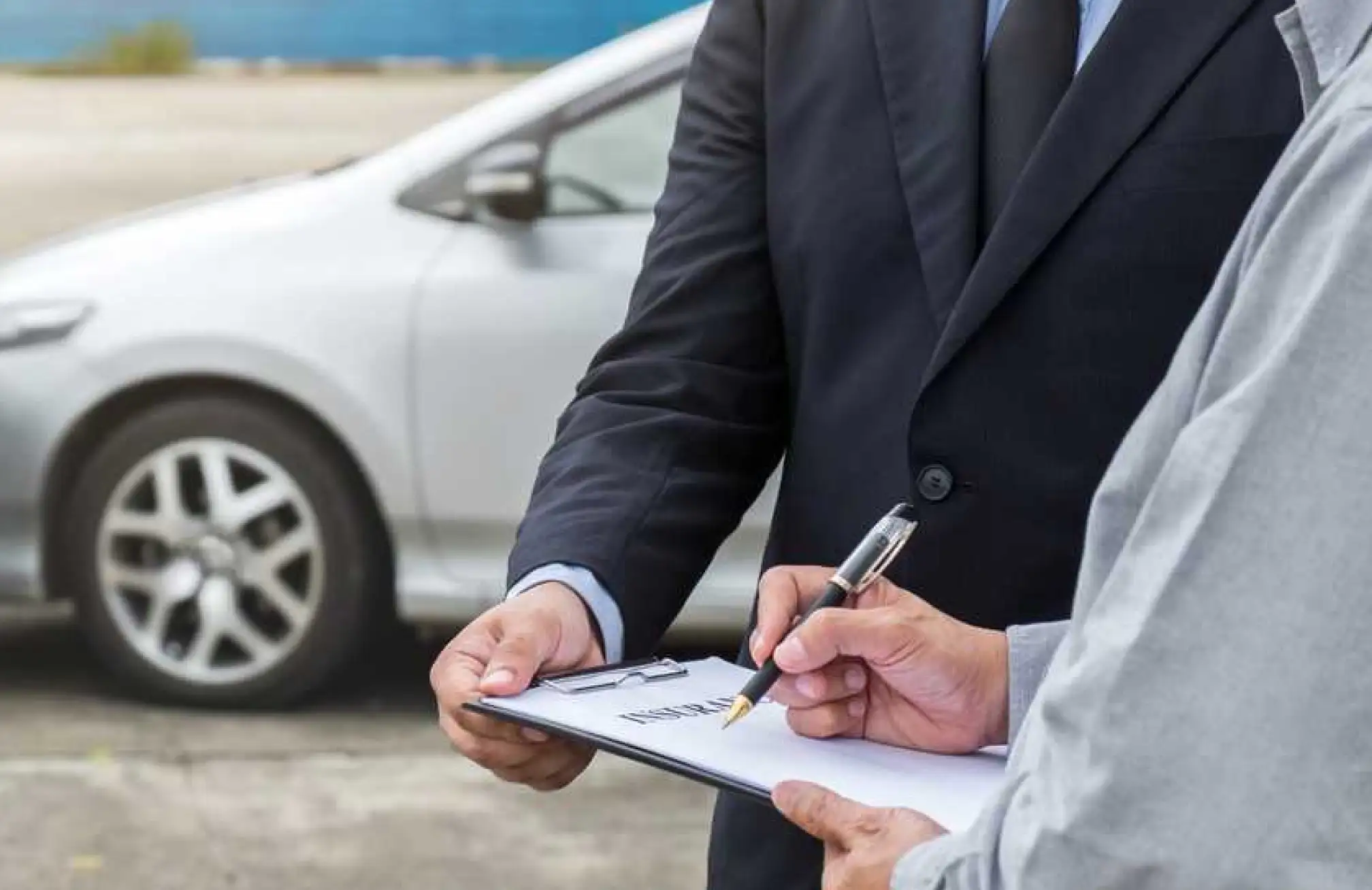 two men signing papers