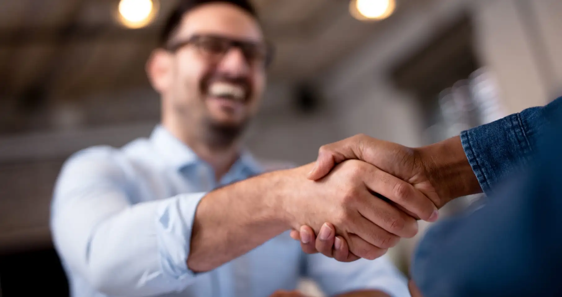 two men shake hands
