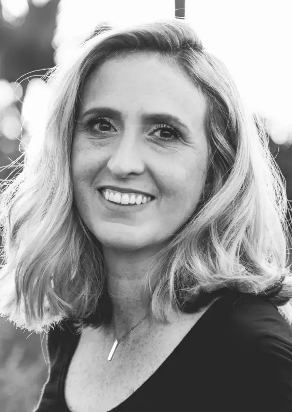 a girl with blond hair smiles