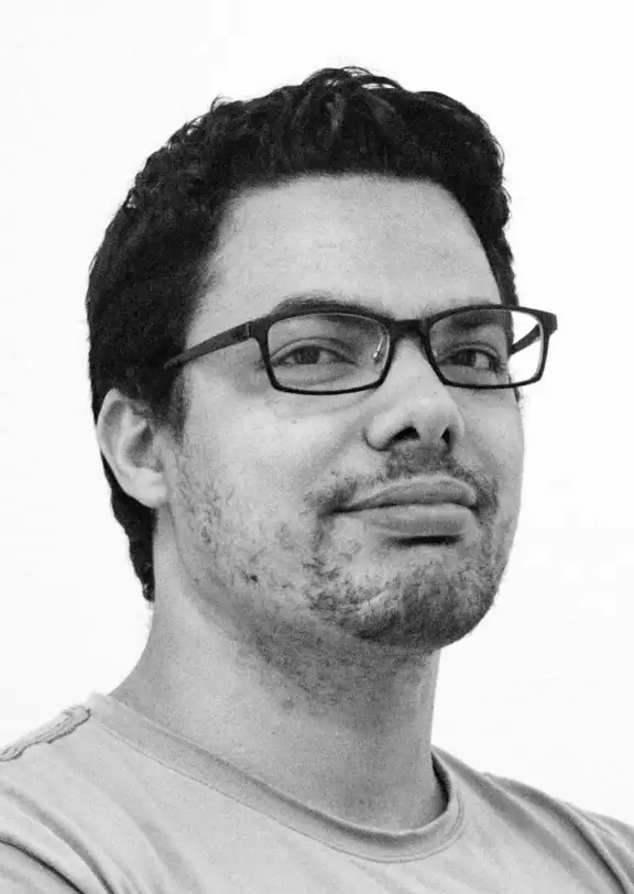 a guy with a short haircut and glasses