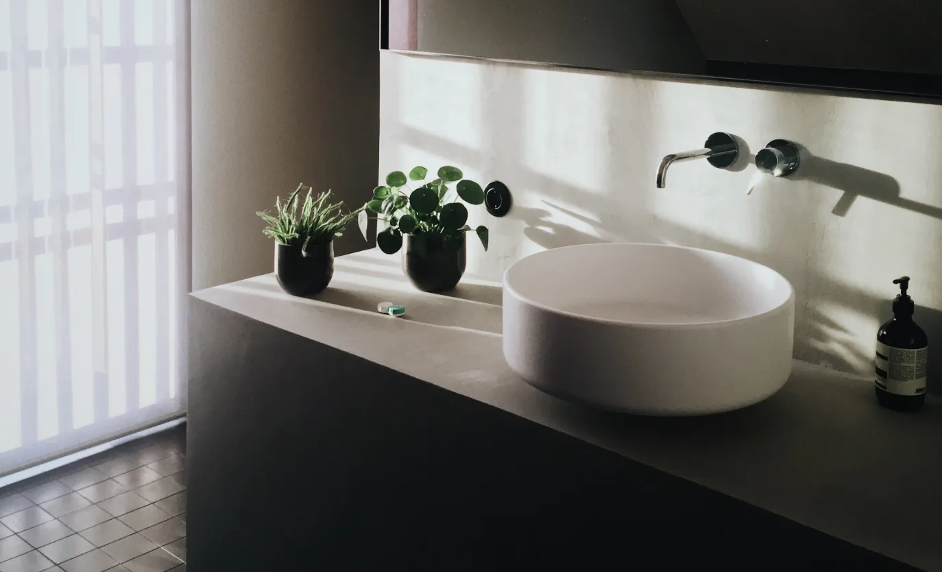 a washstand and flowers stand next to it