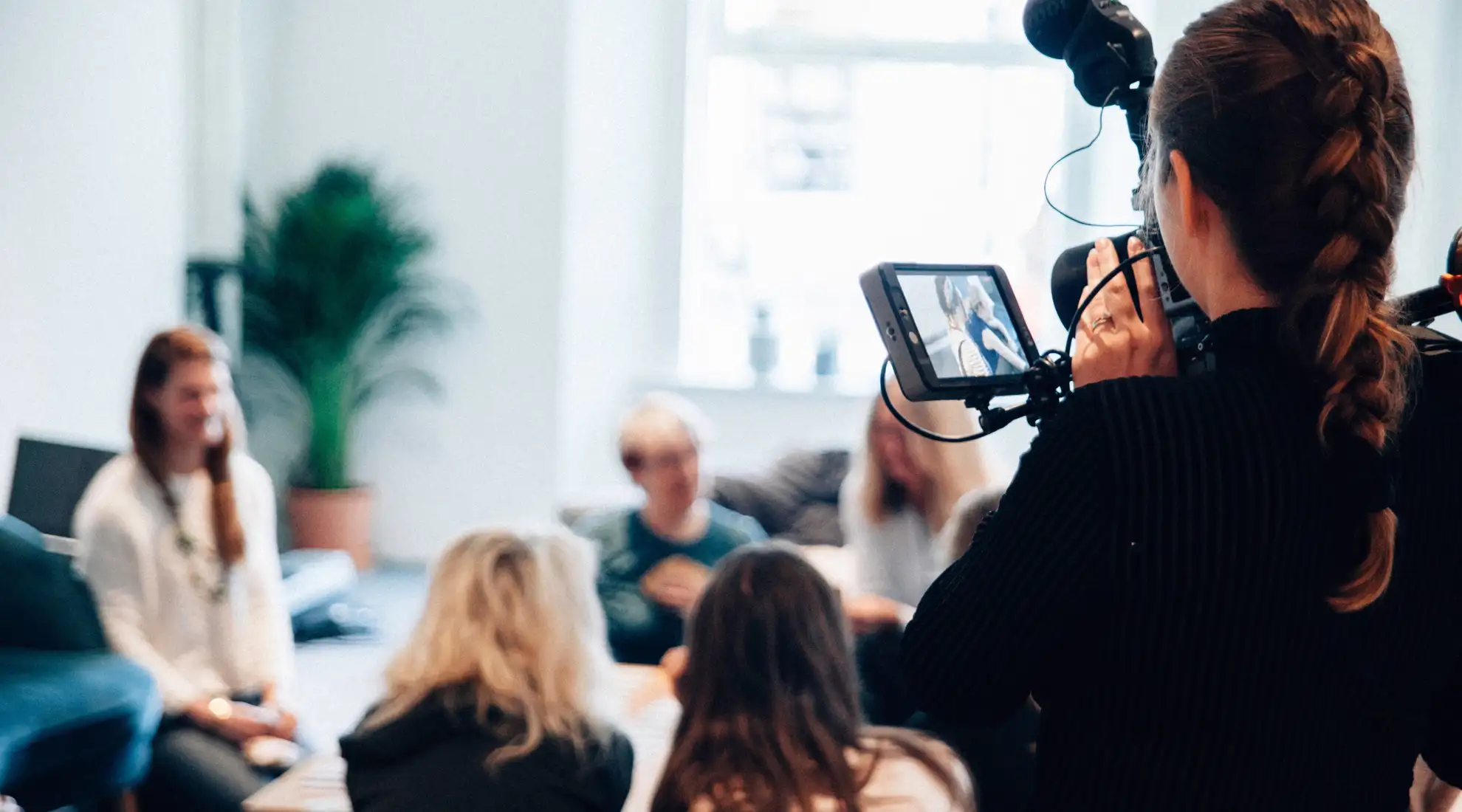 a girl with a camera is filming