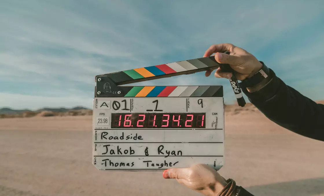 a man holding a device for filming