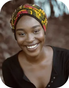 a black woman with headband smiling at the camera