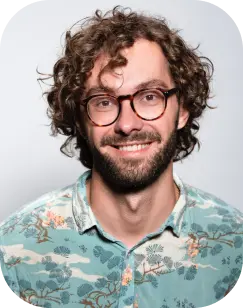 programmer with curly blonde hair and beard wearing glasses and hawaiian shirt