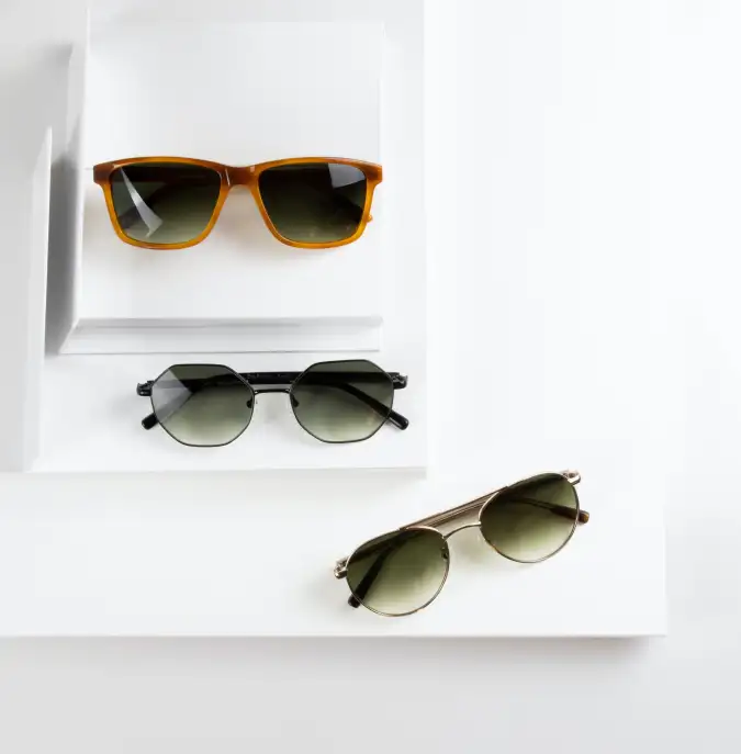 three pairs of different glasses laing on a display