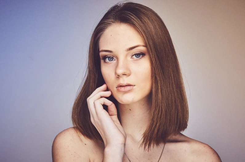 Girl with brown hair has her picture taken for new professional CV created in online portfolio builder