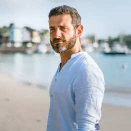 man with brown hair has his picture taken for new professional CV created in online portfolio builder