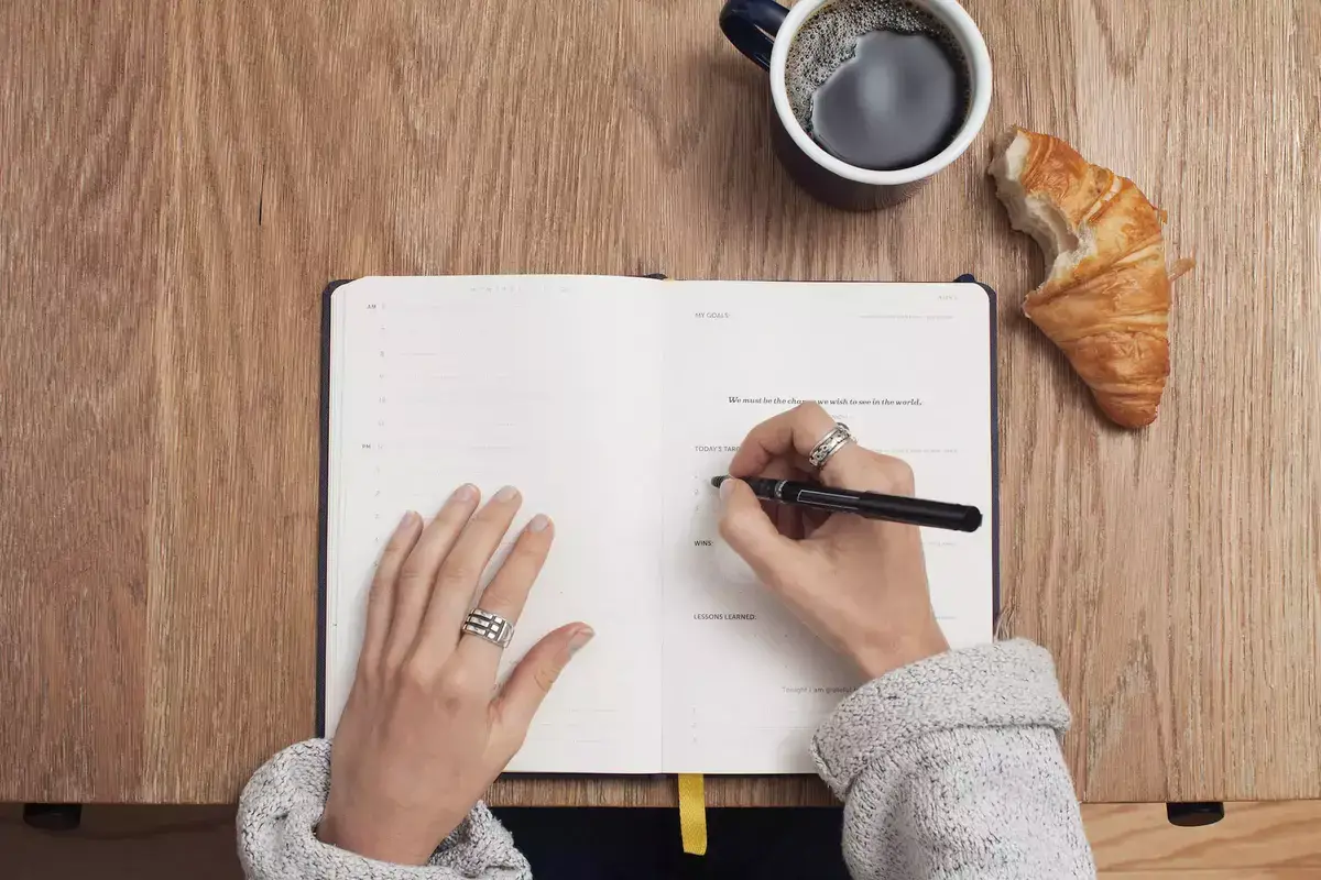 woman writing notes in a notebook
