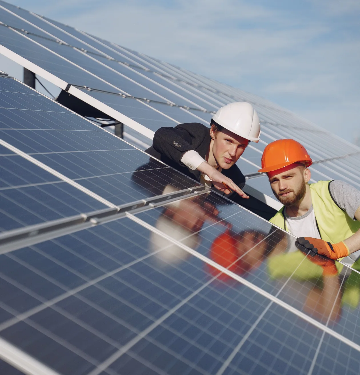 two men checking a solar panel
