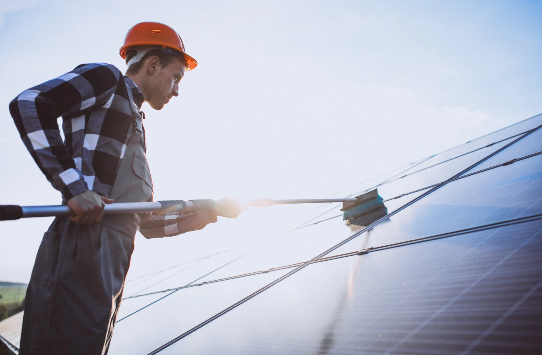 a man cleans solar panels