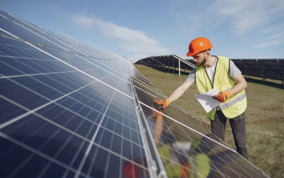 solar panels in the field and a man nearby