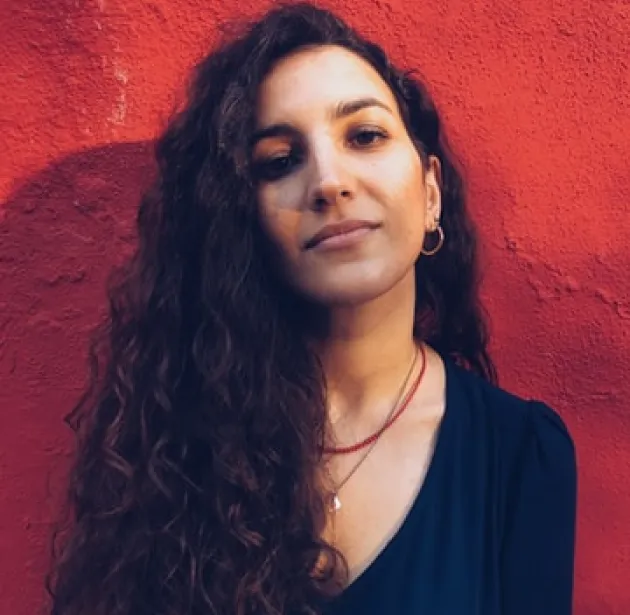 Profile picture of gently smiling woman on a red background