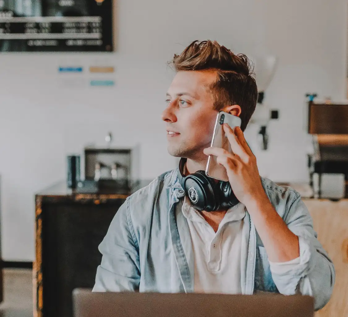 a man in headphones is holding a phone