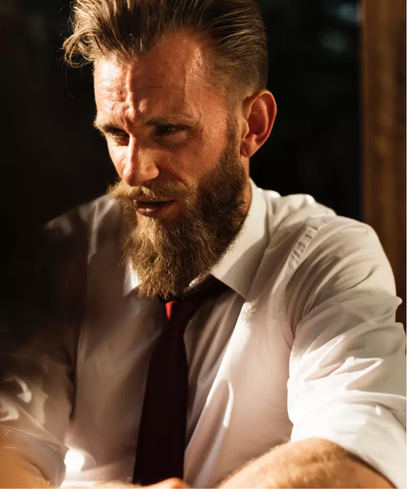 a man with a beard in a white shirt
