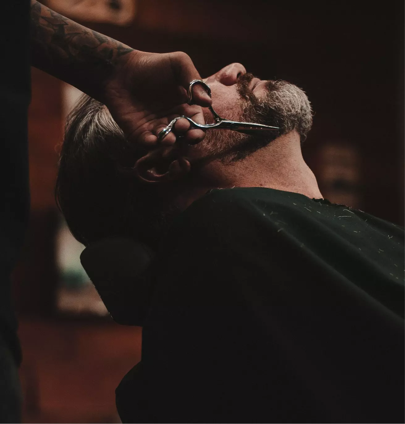 a man's beard is cut