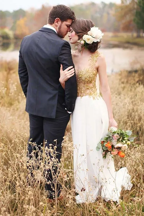 the couple is standing in the grass