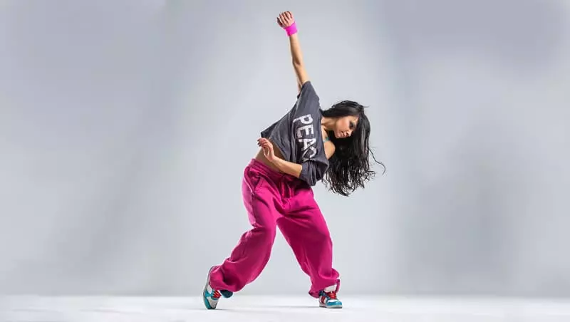 a girl in a hat dances