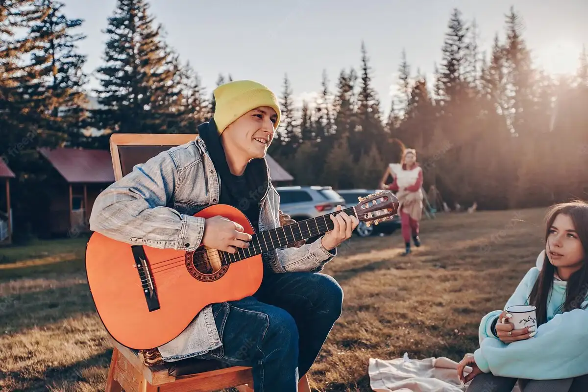 a guy with a guitar and a girl next to him