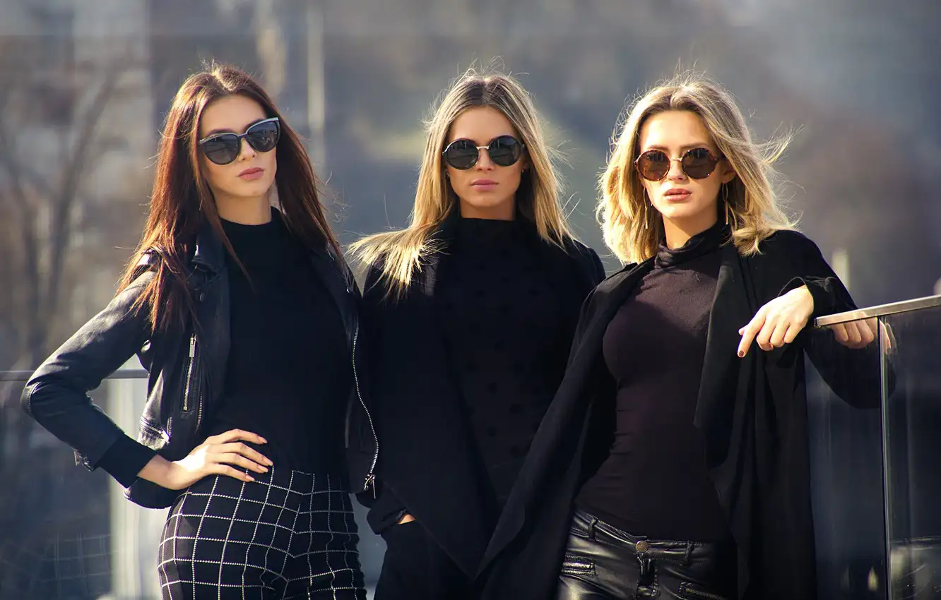 three girls in dark clothes