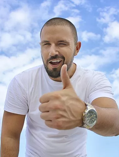 a man in a white T-shirt with a short haircut