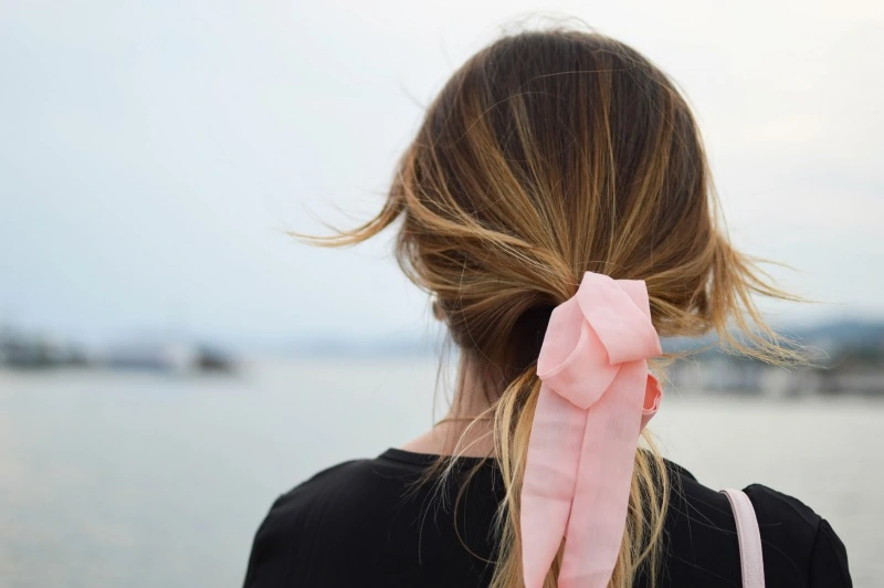 a girl with a bandage in her hair