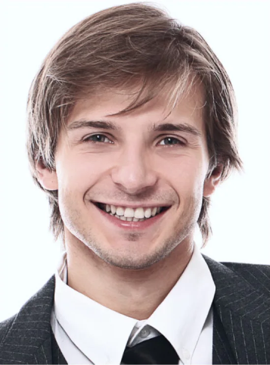 a man in a gray suit smiles 