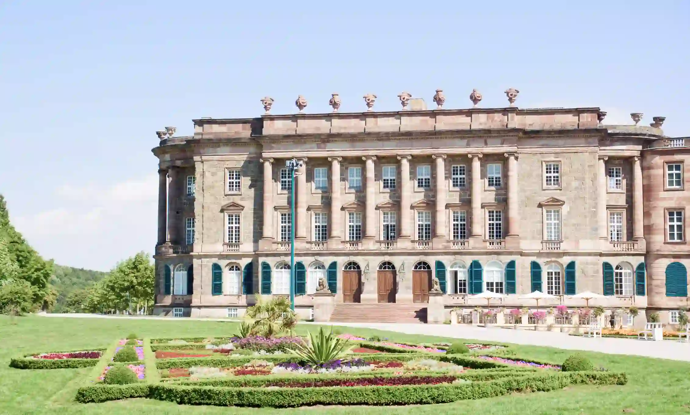 A large building with a yard and flowers