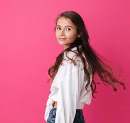 a girl in a light shirt with long dark hair