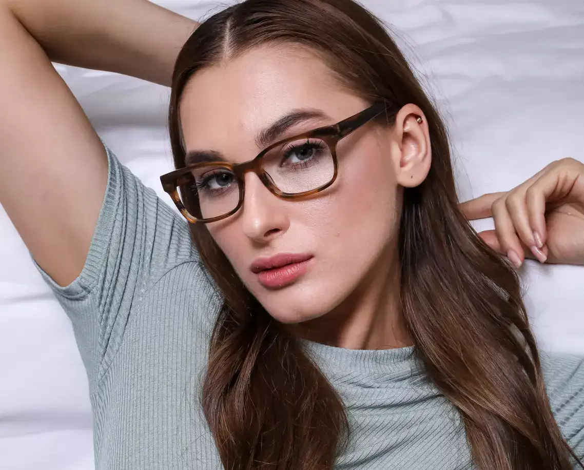 a girl in a gray T-shirt and glasses