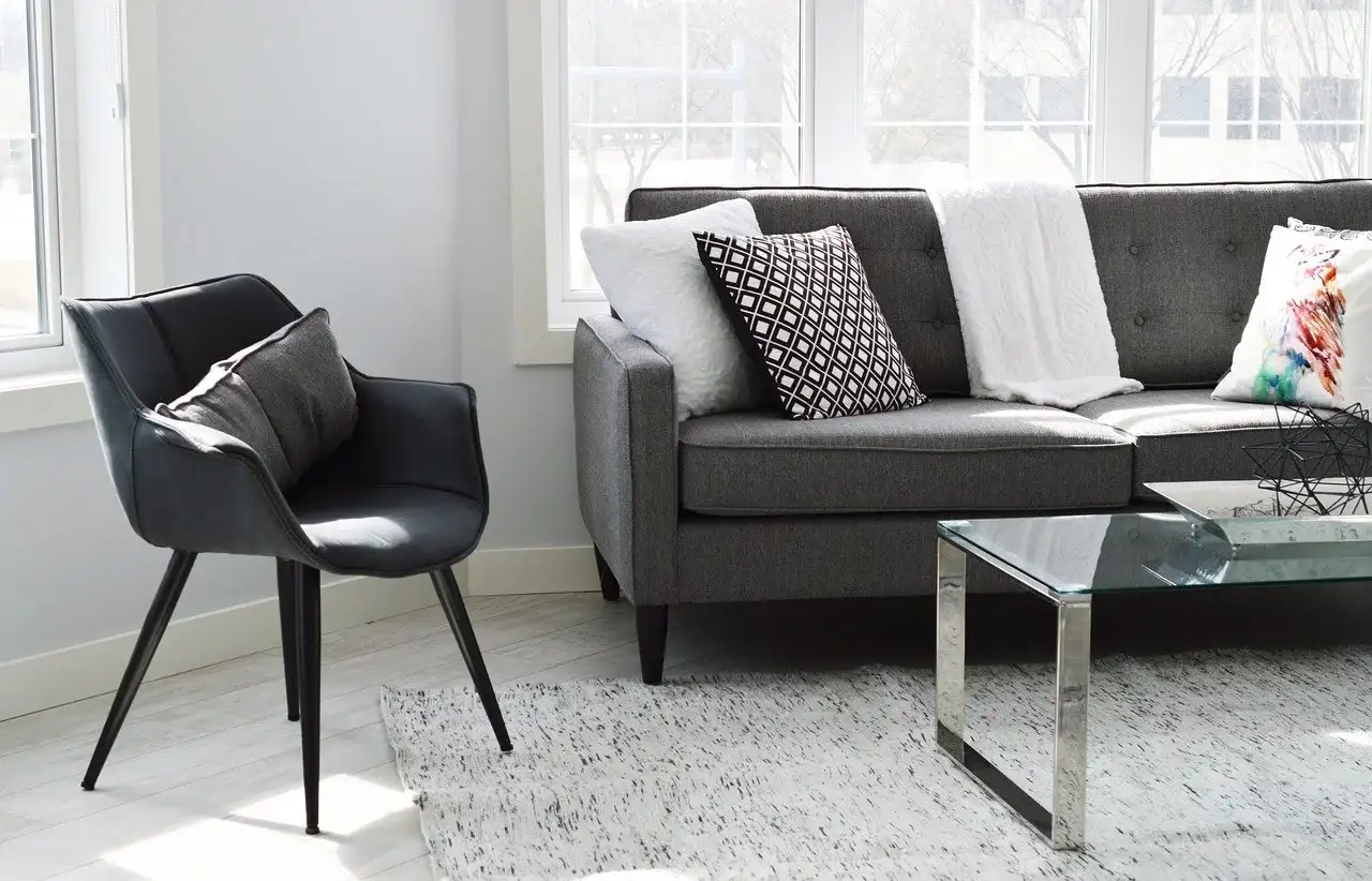 a gray sofa and a chair next to it