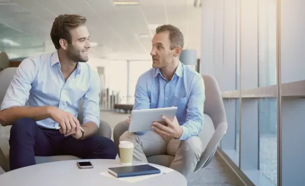 two men sitting in armchairs 