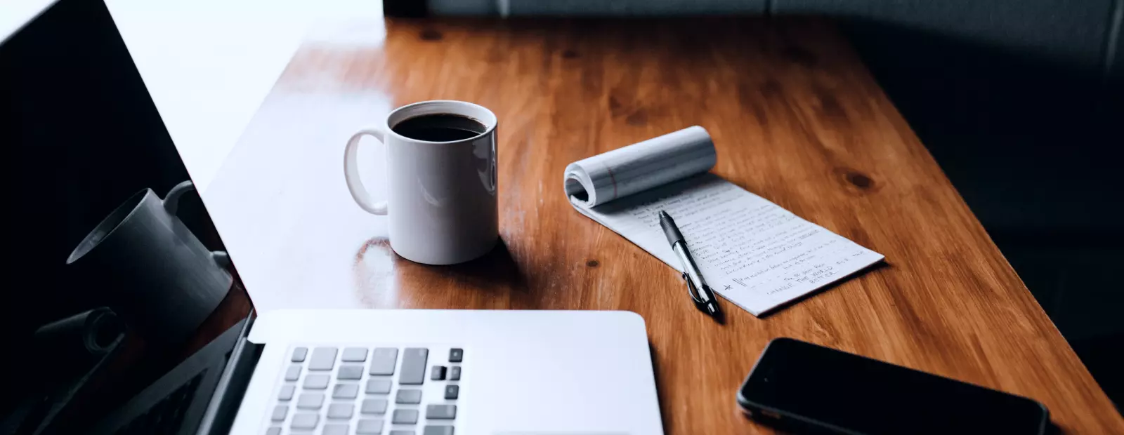 Coffee, laptop, phone on the table
