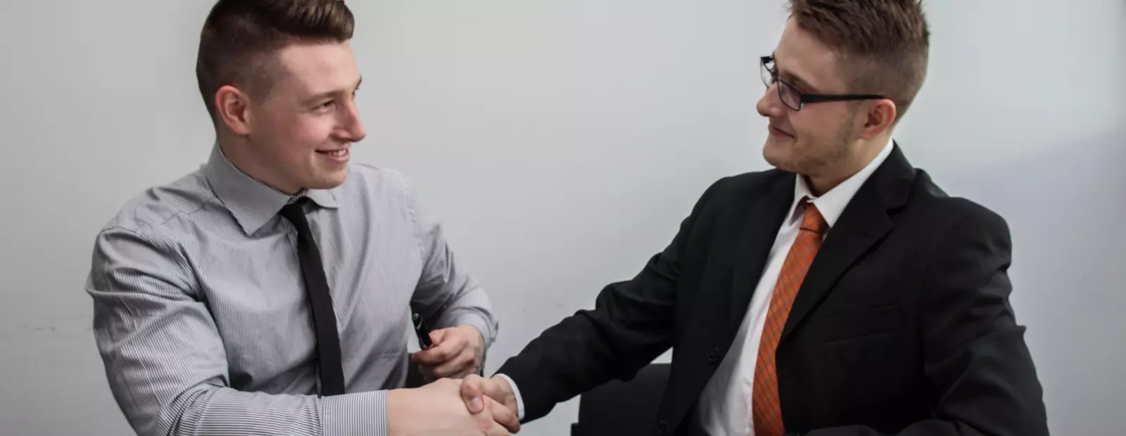 Two men shake hands