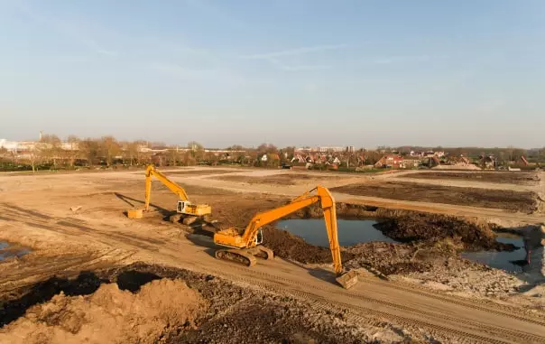 two yellow excavators