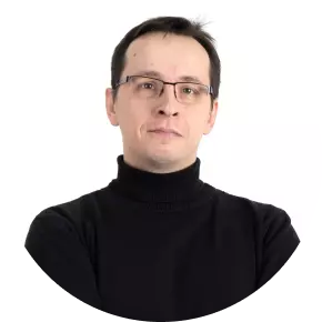 a man with glasses in a dark sweatshirt
