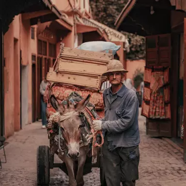 A man walks with a cart
