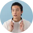 a guy in a white sweatshirt with headphones