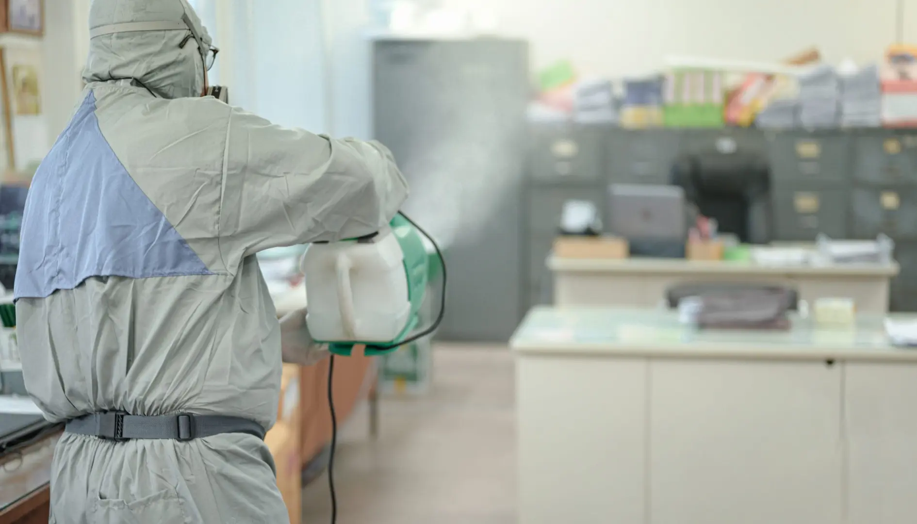 an employee in a protective white suit