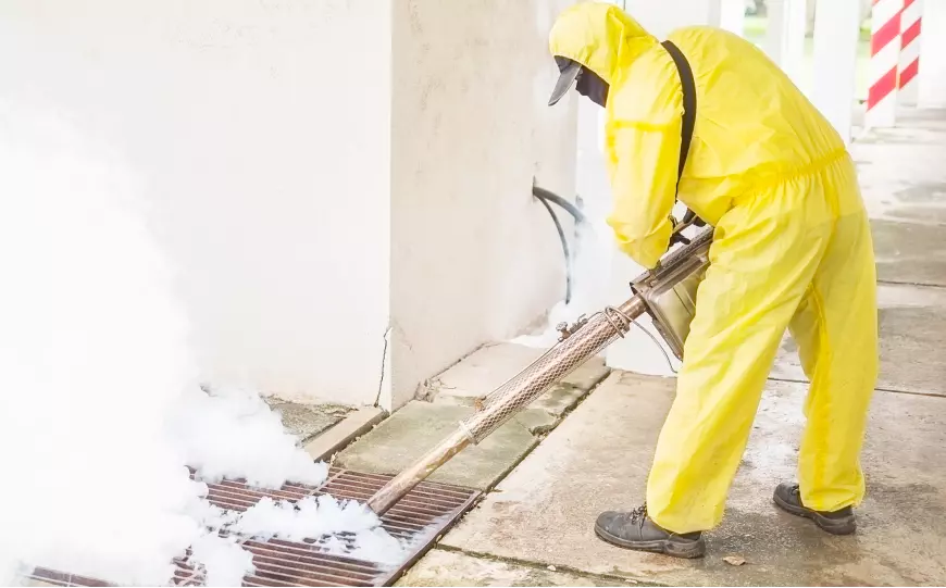 an employee in a protective yellow suit