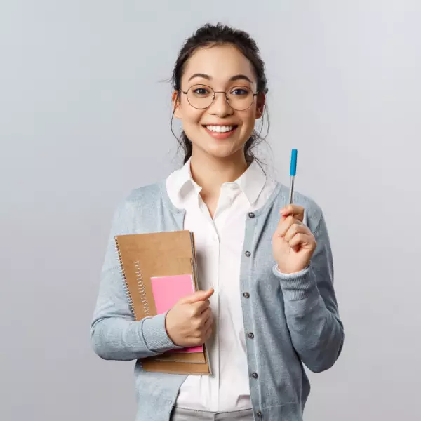 a girl holds books in her hands