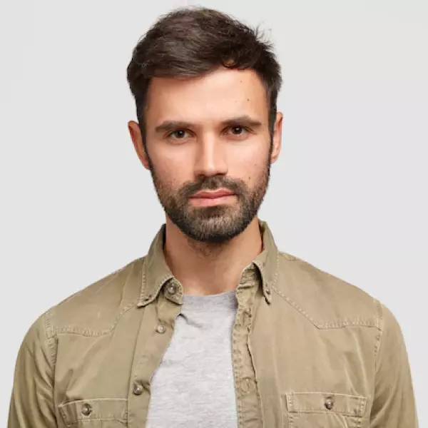 un hombre con una camisa gris y barba