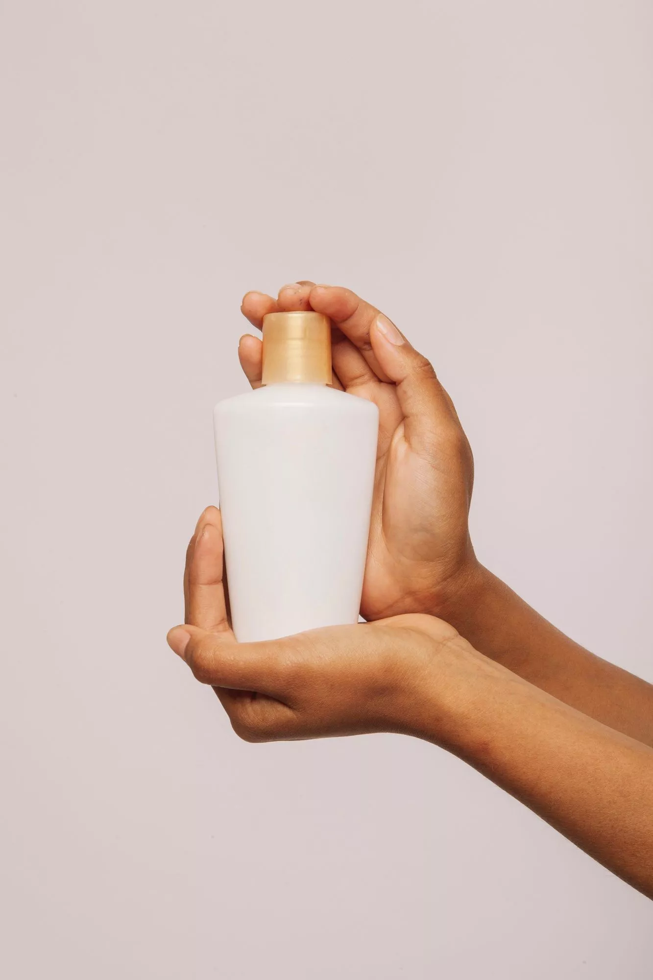 hands with a jar of cream