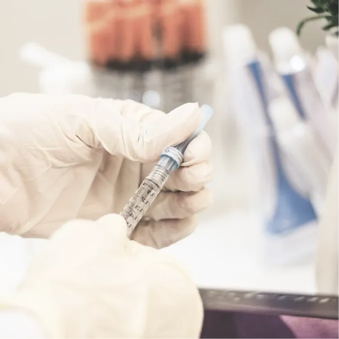 syringe with injection in the hands of a specialist